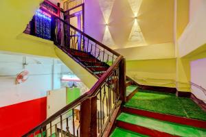 a spiral staircase in a room with colorful walls at SPOT ON Rainbow Lodge in Guwahati