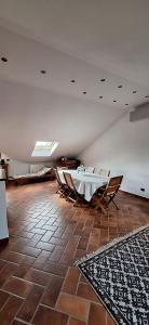a room with a table and chairs and a rug at Roby53 in Parabiago