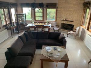 a living room with a couch and a table at Elis superb house in Psathíon