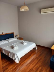 a bedroom with a bed with two pillows on it at Elis superb house in Psathíon