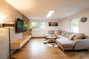 a living room with a couch and a table at Apartmány Slanica in Námestovo
