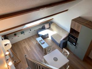 a small living room with a couch and a table at 2 chambres avec mezzanine in Le Lioran +19 photos