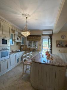 a large kitchen with a large island in the middle at Villa Kastri in Igoumenitsa