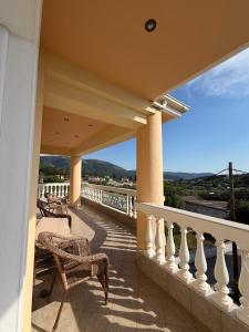 a balcony with chairs and a view of the ocean at Villa Kastri in Igoumenitsa