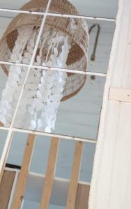 a chandelier hanging from the ceiling of a room at Coco Beach Cupel - Domek AQUA z jakuzzi in Cupel