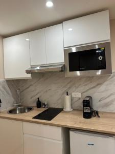 a kitchen with a sink and a microwave at Studio design in Beaune