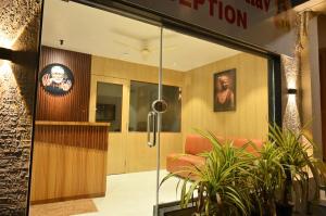 a lobby with a waiting room and a glass door at Hotel Sai Vaibhav in Shirdi