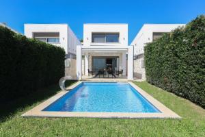a villa with a swimming pool in front of a house at Villa Mare 3 - Private Pool, Sea View in Hanioti