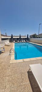a large blue swimming pool on a building at rev'hotel in Vias