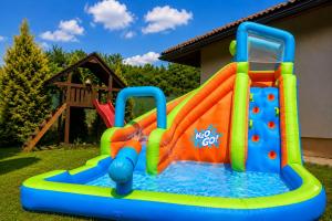a colorful inflatable water slide in a yard at Family Bungalov Banská Bystrica in Banská Bystrica