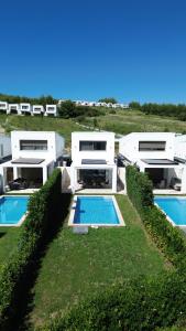 an aerial view of a house with two swimming pools at Villa Mare 3 - Private Pool, Sea View in Hanioti