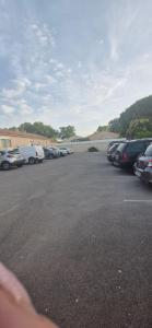 a parking lot filled with lots of parked cars at rev'hotel in Vias