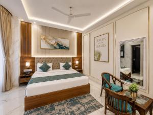 a bedroom with a bed and a desk and a chair at The Comfort Villa Manage By Bellamount Hotel Free Airport Pick Up & Drop in New Delhi