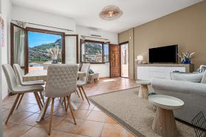 a living room with a couch and a table and chairs at Agio Porto Cervo in Liscia di Vacca