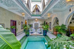 an indoor pool in a building with plants at Riad Samir Oasis And Spa in Marrakesh