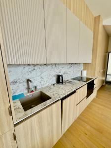 a kitchen with a sink and a counter top at V7 Apartamentai Nidoje in Nida