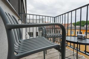 a pair of benches sitting on a balcony at Resume apartments in Kaunas