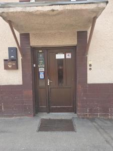a front door of a building with a brown door at Laguna ubytovanie 2 A in Trenčín +15 photos