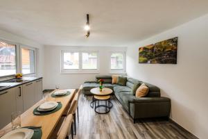 a living room with a couch and a table at Apartmány Slanica in Námestovo