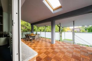 a room with a wooden floor and a dining table at Apartmány Slanica in Námestovo