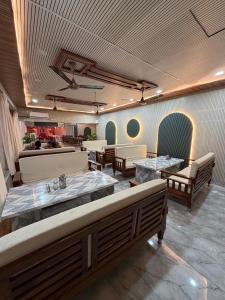 a restaurant with tables and couches in a room at Hotel Nalanda City in Nalanda