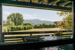 a table and chairs on a balcony with a view at Chiemgau Nest II in Siegsdorf