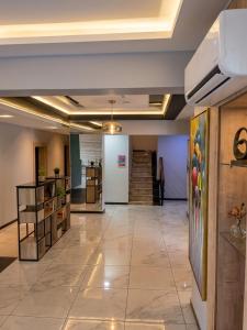 a lobby of a building with a tile floor at Edge ONE Resort in Gwarinpa