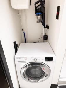 a washer and dryer in a small room at The Regent in Warrington +21 photos