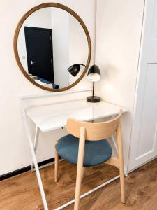 a desk with a chair and a mirror at The Regent in Warrington