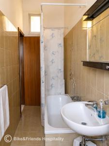 a bathroom with a sink and a tub and a toilet at CASA BETTI in Pesaro +10 photos