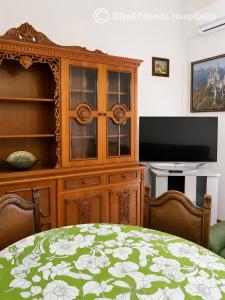 a room with a wooden hutch and a tv at CASA BETTI in Pesaro