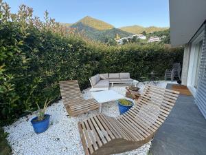 a patio with two chairs and a couch and a table at Montebello in Bellinzona +1 photo