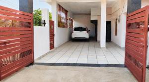a white car parked in a hallway of a house at Jaiswal Homestay in Jabalpur