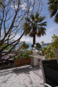 a laptop sitting on a table with a view of the ocean at Hotel Magllara in Sarandë +23 photos