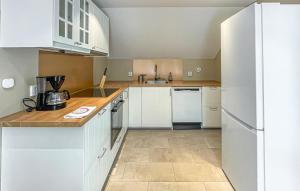 a kitchen with white cabinets and white appliances at 1 Bedroom Lovely Apartment In Värnamo in Värnamo