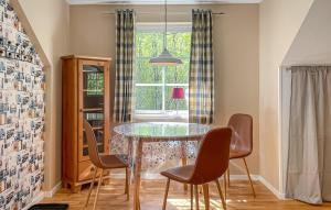 a dining room with a glass table and chairs at 1 Bedroom Lovely Apartment In Värnamo in Värnamo