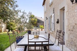a wooden table and chairs on a patio at Lacelledort in La Celle-Saint-Avant
