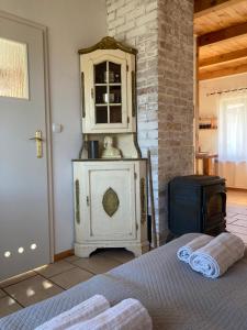 a bedroom with a bed and a cabinet and a stove at Biały Zdrój in Kalisz Pomorski +10 photos