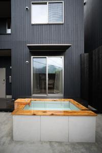 a building with a swimming pool in front of a building at Shiki Art Hotel Yufu in Yufu