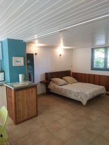 a bedroom with a bed and a table in it at La Biro in Pornic