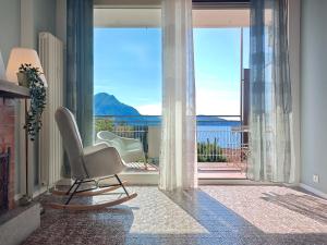 a living room with a chair and a large window at Star Lake in Intra
