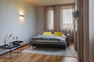 a bedroom with a bed with two yellow pillows at ipartment Leverkusen @HOME by Best Western in Leverkusen