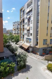 an empty street in front of tall buildings at Dream Luxury Suite in Tirana