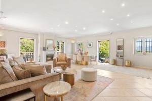 a living room with a couch and a table at Villa Seize St Tropez in Saint-Tropez