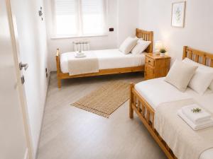 a bedroom with two beds and a window at La Casa al Mare in Pescara