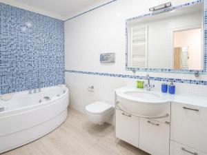 a bathroom with a tub and a toilet and a sink at La Casa al Mare in Pescara