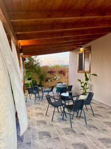a patio with tables and chairs on a patio at Alesia's Guesthouse in Vlorë