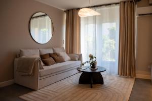 a living room with a couch and a table at 1 Peraudel Suite & Appartements in Castres