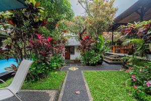 a garden with a bench and some plants at Pondok Alami Villas 5BR & Pool in Ubud