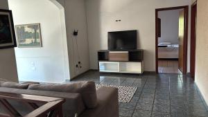 a living room with a couch and a flat screen tv at Casa confort - Vicente pires in Brasília